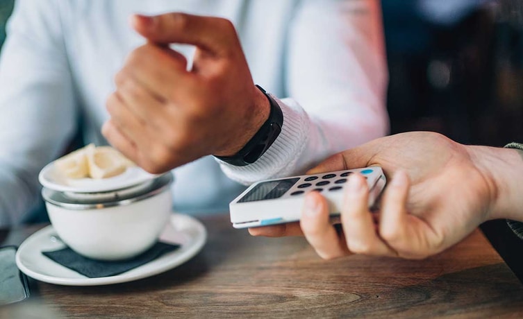 Mann betaler kaffe med FitBit - Pay