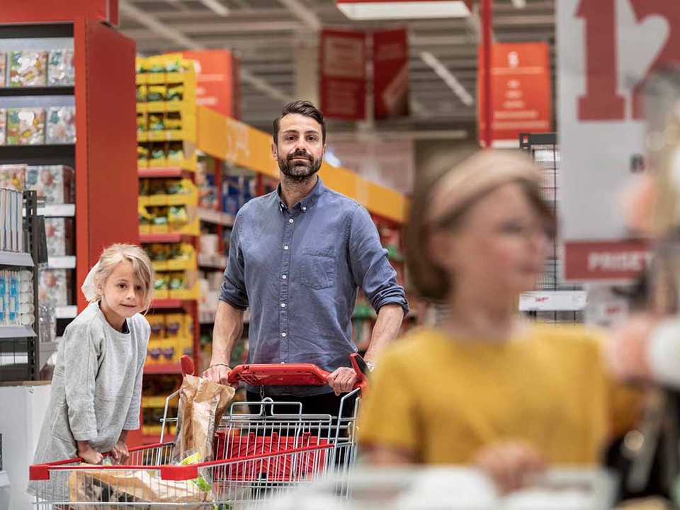 Far på handletur i matbutikken med datter, til illustrasjon for 50-30-20 regelen