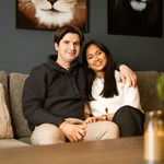 Mann holder armen rundt kvinne mens de sitter i sofaen, til illustrasjon for Finit erfaringer